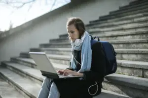 A girl sitting and taking online classes